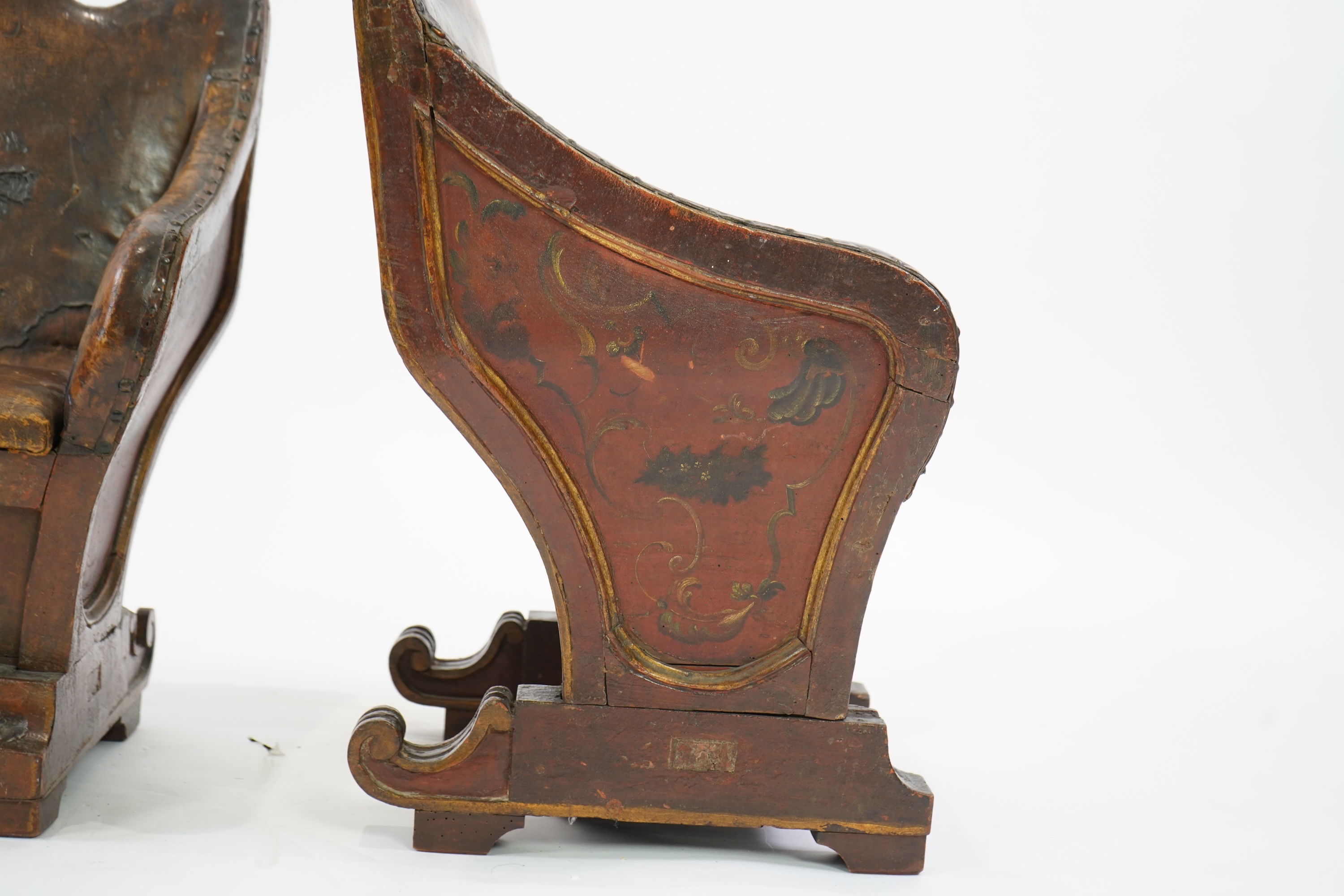 A pair of 19th century Venetian carved wood and tan leather Gondola seats
